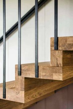 the stair railings are made from wood and metal