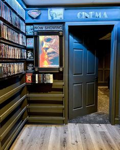 an open door to a movie theater with dvd's on the shelves