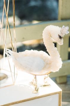 a white swan statue sitting on top of a table