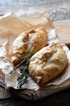 two pastries sitting on top of a piece of wax paper