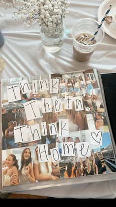 a table topped with pictures and writing next to a vase filled with baby's breath flowers