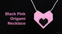 a pink origami necklace with two hearts on it and the words, black pink origami necklace