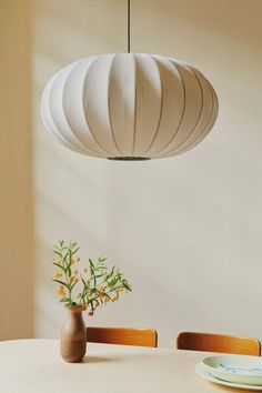 The Made by Hand Knit-Wit Pendant Light - Oval suspended over a dining table with a vase, flowers and plate. Japanese Lighting, Paper Chandelier, Paper Lanterns Diy, Chinese Paper Lanterns, Bamboo Pendant Light, Rattan Pendant Light, Design Objects, Handmade Lamps, Knitted Wit