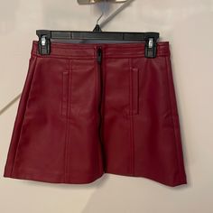 Wine Faux Leather Mini Skirt Chic Faux Leather Mini Skirt With Zipper, Chic Faux Leather Skirt With Zipper Closure, Fall Faux Leather Mini Skirt With Zipper, Faux Leather Mini Skirt With Zipper For Fall, Chic Burgundy Skirt For Spring, Chic Red Leather Bottoms, Fall Faux Leather Skirt With Zipper Closure, Chic Fall Skirt With Zipper Closure, Trendy Red Mini Skirt For Work