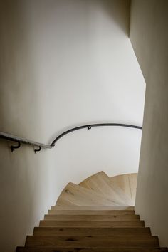 an empty staircase with wooden steps leading up to the top