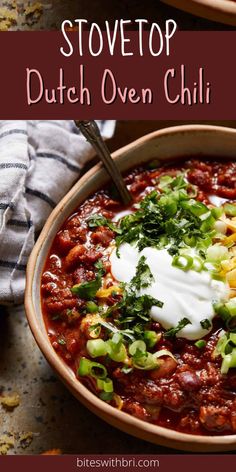 a bowl filled with chili and sour cream