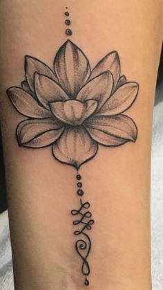 a lotus tattoo with the word love written in cursive writing on its side