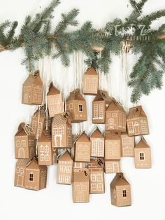 a group of gingerbread houses hanging from a christmas tree