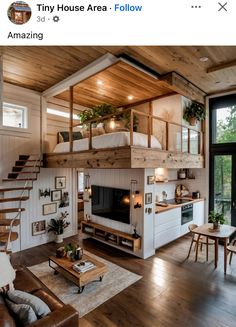 a living room filled with furniture and a fire place under a loft bed next to a window