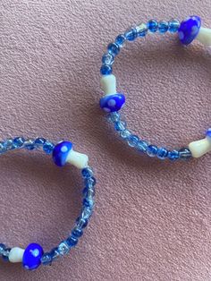 This handmade bracelet was made with a. stretchy band to fit all! The beads used a blue with shimmer along with three blue mushrooms! Mushroom Bracelet, Mushroom Blue, Blue Mushrooms, Blue Mushroom, Stretchy Beaded Bracelet, Manchester Nh, Beads Bracelet Design, Jewelry Blue, Bracelet Design