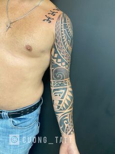 a man with tattoos on his arm and chest