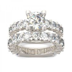 a wedding ring set with an oval cut diamond surrounded by smaller round diamonds on each band