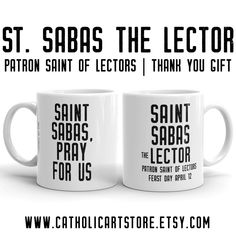 two white coffee mugs sitting next to each other with the words saint sabos and pray for us on them