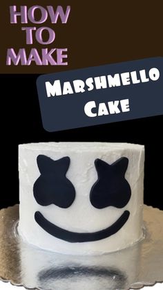 a white cake with black cats on it and the words how to make marshmello cake