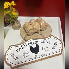 an egg tray with eggs on it and a sign for farm fresh eggs next to it