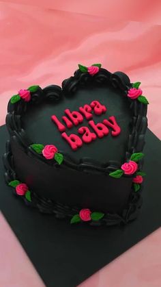 a heart shaped cake with the words happy baby written on it