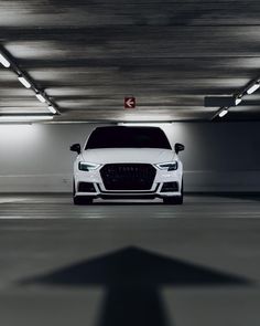 a white car parked in a parking garage