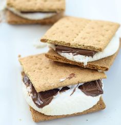 three graham crackers are stacked on top of each other with marshmallows and chocolate