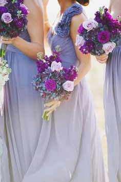 the bridesmaids are holding their bouquets in each other's hands and kissing