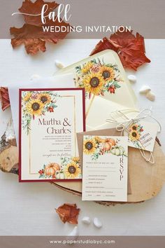 wedding stationery with sunflowers and fall leaves on the table for an autumn or fall wedding