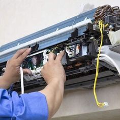 a man is working on an electrical panel