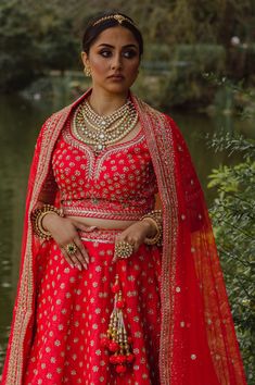 Kakar - Red Bridal Silk Indian Contemporary Lengha w/ Dabka work Live your fantasies come true in this one of a kind red bridal lehenga choli this bridal season! Dupion silk choli blouse w/ Dabka embroidery Sweetheart neckline choli blouse Luxurious dupion silk fabric blouse Mid-length sleeve with embroidery Beautiful Dabka embroidery all over Elaborately embroidered borderwork Lightweight dupion silk lengha w/ Dabka & Sequins Feather-light dupion silk skirt Yards of fabric used for max flare Go Designer Bollywood Choli With Tilla Detailing, Bollywood Style Designer Choli With Tilla, Red Raw Silk Lehenga For Wedding, Red Dupatta With Tilla Detail, Designer Raw Silk Choli With Tilla Details, Traditional Red Anarkali Set With Tilla, Red Tilla Lehenga For Navratri, Designer Raw Silk Choli With Tilla, Red Choli For Navratri With Kundan Style