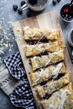 blueberry scones on a cutting board next to cups and spoons