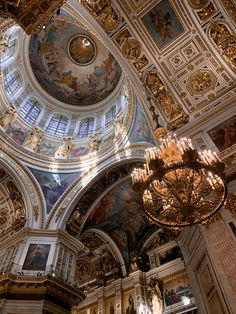 an ornate ceiling with chandeliers and paintings on it