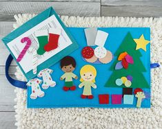 a blue mat with felt christmas decorations on it