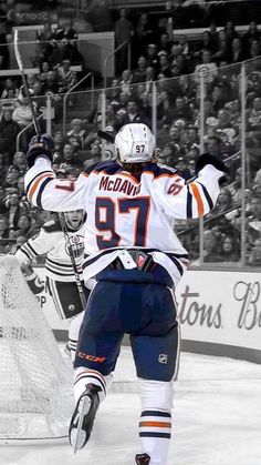 an image of a hockey player on the ice with his arms in the air and one hand up