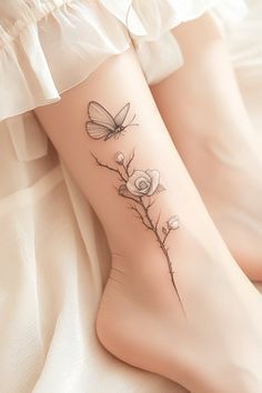 a woman's legs with flowers and butterflies on them