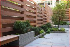 an outdoor garden with wooden fence and benches