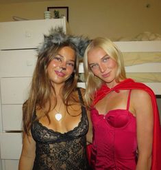 two women dressed up in costumes posing for the camera