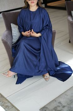 Indulge in our newest premium collection Luxe Malikah Abaya - A gorgeous shade of blue. The beautifully draped flow of the sleeves and luxurious premium satin will make you feel like a Malikah - Queen, it is definitely a show stopper abaya. This abaya comes with a contrasted hijab & under layer dress.   Please check your size before ordering to avoid any complications. Anymore questions please feel free to ask  * Material: premium satin * Model wears size 54inch - model is 5 ft 2 * fabric can di Abaya Party Dress, Party Dress Modest, Party Abaya, Silk Abaya, Eid Abaya, Modest Abaya, Dress Modest, Layer Dress, Silk Organza