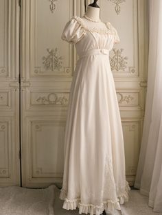 Immerse yourself in the elegance of the Regency era with this exquisite cream Bridgerton-inspired dress. Perfect for brides and special occasions, this gown combines vintage charm with luxurious details, making it a timeless addition to your wardrobe. Elegant Design: Featuring a classic Regency silhouette, this dress boasts puffed sleeves and a gracefully flowing skirt. The delicate chiffon ruffles and floral appliqués add a touch of romantic charm, while the beaded embellishments enhance its sophisticated appeal. Charming Details: The gown is adorned with intricate floral appliqués and beading, showcasing superior craftsmanship. The waist is cinched with a ribbon bow, creating a flattering and elegant fit that accentuates your figure. Premium Fabric: Crafted from high-quality fabric, this Regency Era Nightgown, Regency Nightgown, Regency Silhouette, Regency Era Dress, Regency Dresses, Nontraditional Wedding Dress, Wedding Dresses High Low, Floral Applique Dress, Bridgerton Inspired