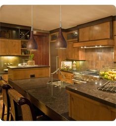 a large kitchen with wooden cabinets and granite counter tops, an island in the middle