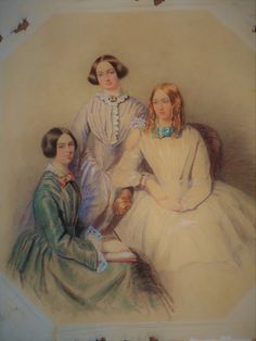 three women in dresses sitting next to each other