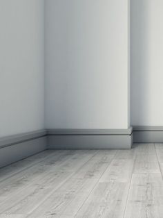 an empty room with white walls and wood flooring is pictured in this image, there are no people