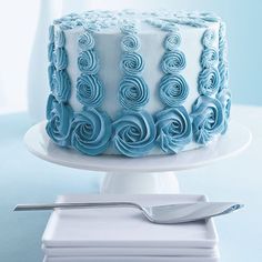 a white and blue cake with swirls on it