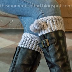 a woman's legs wearing black boots with white knitted booties