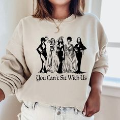 a woman wearing a sweatshirt that says you can't sit with us