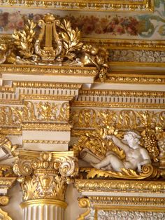 ornate gold and white decorations on the ceiling