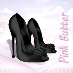 a pair of black high heeled shoes sitting on top of a book