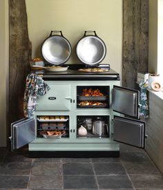 an old fashioned stove with two pots and pans on it's burners