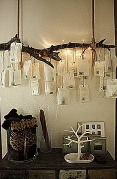 there are many bags hanging on the wall next to a table with pictures and other items