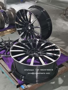 some black and chrome wheels are stacked on top of each other