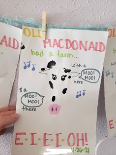 two children's handmade posters hanging on a wall with music notes attached to them