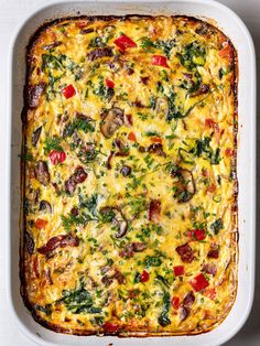 a casserole dish filled with vegetables and cheese