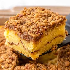 a close up of a piece of cake on a spoon with some crumbs