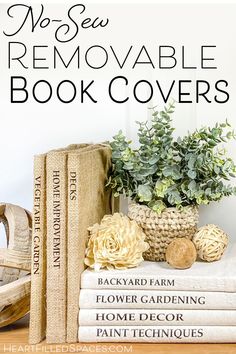 a stack of books sitting on top of a table next to a potted plant